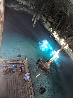 Dr. Marshall and students looking up surrounded by water