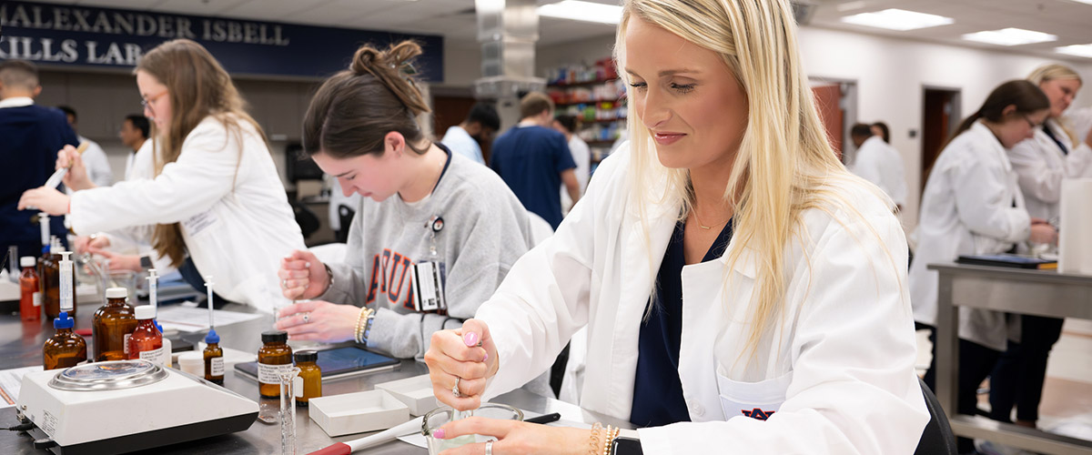 Students working in pharmacy lab.