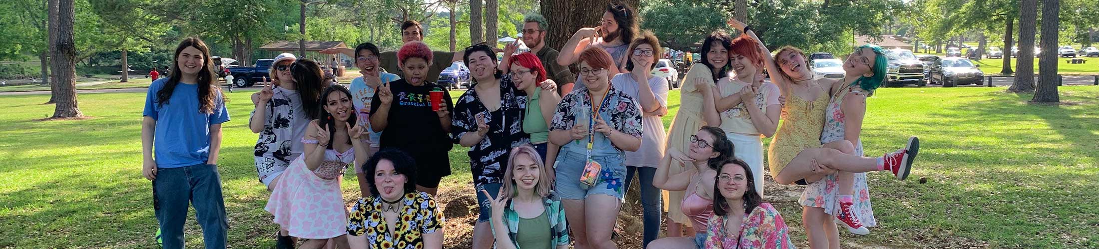 Group of Spectrum students outside in front of a tree on campus.